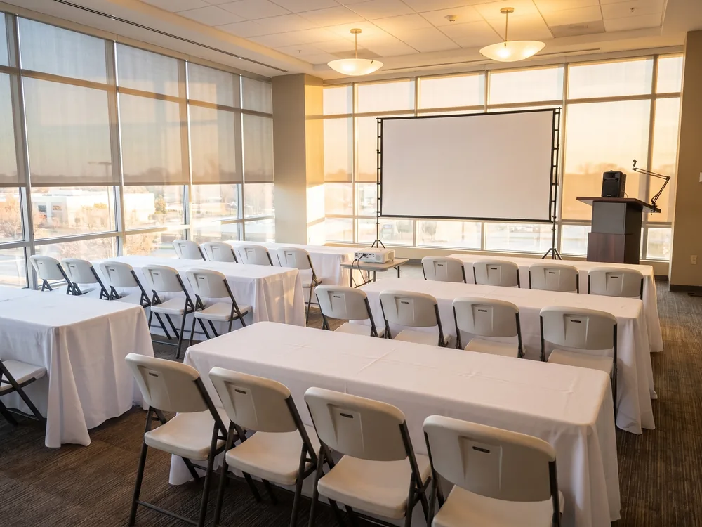 Corporate Presentation: Bright 1080p Projector, 150 in Projection Screen, Podium, Battery PA Speaker + 3 Wireless Mics, 6 ft Folding Table, Folding Chairs, Set of 10