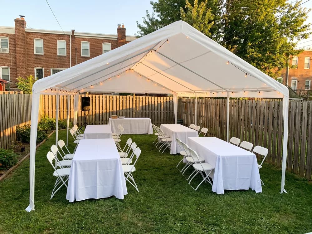 Covered Backyard Party: 10 × 20 Party Tent, 6 ft Folding Table, Folding Chairs, Set of 10, Battery PA Speaker + 3 Wireless Mics